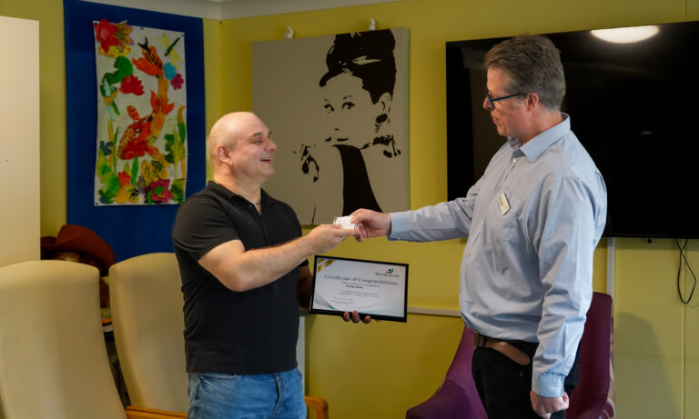 Tino receiving his certificate from Michael.